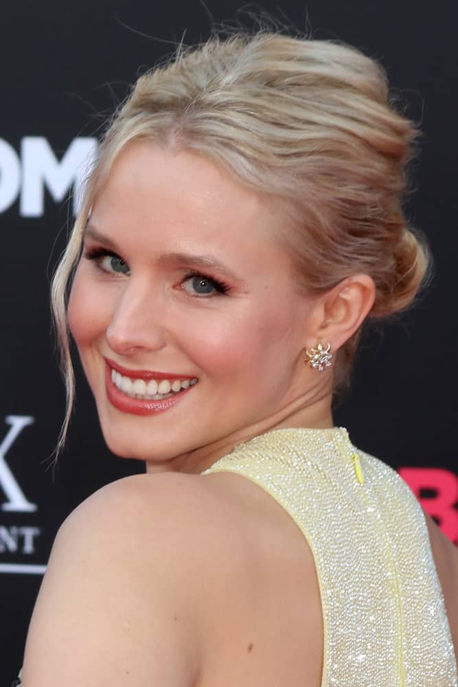 Kristen Bell styled her blonde locks in a messy bun with a side tendril during the "Bad Moms" Los Angeles Premiere at the Village Theater on July 26, 2016