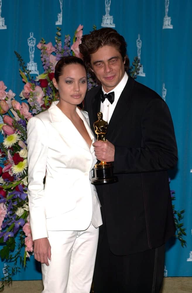 Actress Angelina Jolie and benicio Del Toro were at the 73rd Annual Academy Awards in Los Angeles on March 25, 2001. Jolie wore a smart casual white suit with her slicked back bun hairstyle.