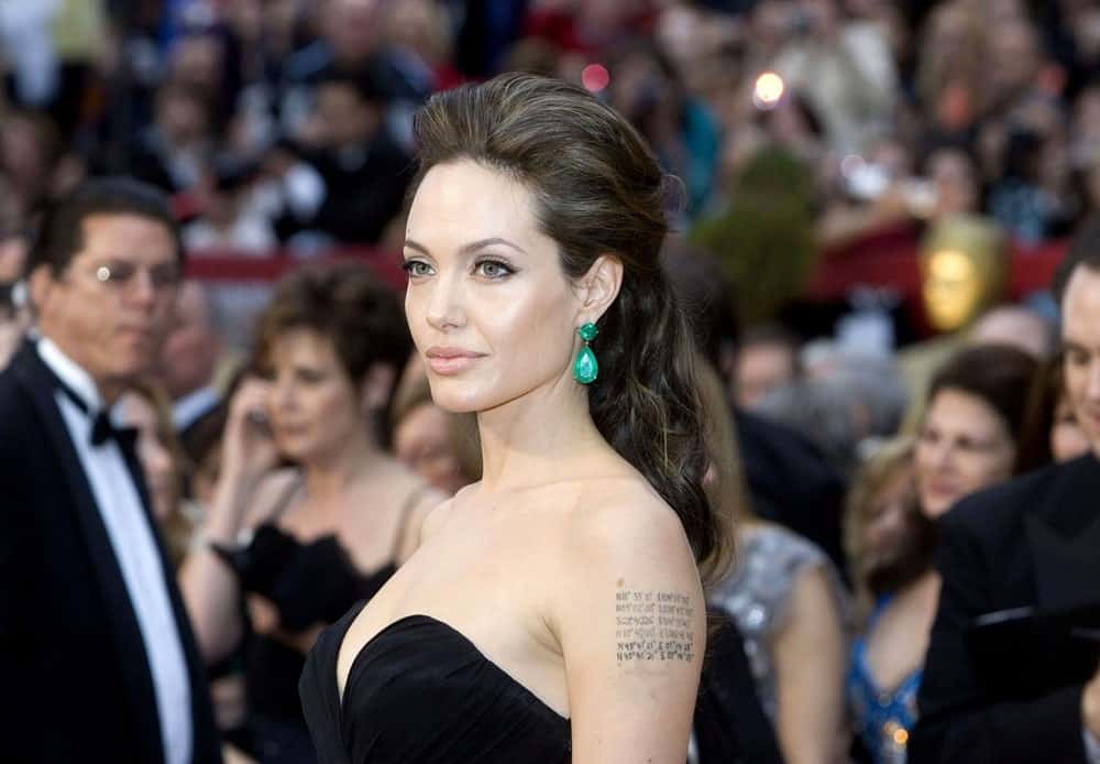 Angelina Jolie emphasized her Lorraine Schwartz earrings with a beautiful black strapless dress and a loose tousled half up hairstyle with highlights at the 81st Annual Academy Awards held at the Kodak Theatre in Los Angeles, CA on February 22, 2009.
