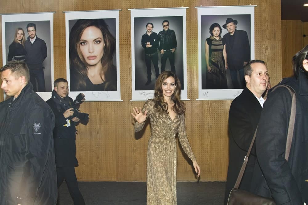 Angelina Jolie attended the 'In The Land Of Blood And Honey' during of the 62 Berlin Festival at the Haus der Berliner Festspiele on Feb. 11, 2012 in Berlin, Germany. She was quite lovely in her golden dress and long dark brown hairstyle with curls at the tips.
