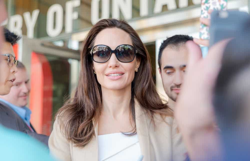 Angelina Jolie signed some autograph for the fans after the Women in the World Canada Summit during the 2017 Toronto International Film Festival on September 11, 2017 in Toronto, Canada. She wore a pair of cool sunglasses to go with her loose and tousled straight hairstyle.
