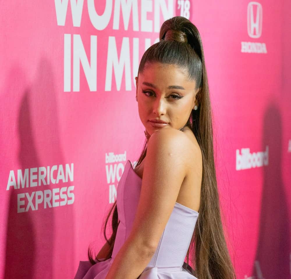 Ariana Grande flaunts her long, straight hair in a sky high ponytail at the Billboard's 13th Annual Women in Music gala on December 6, 2018. She paired it with a gray tube dress by Christian Siriano.