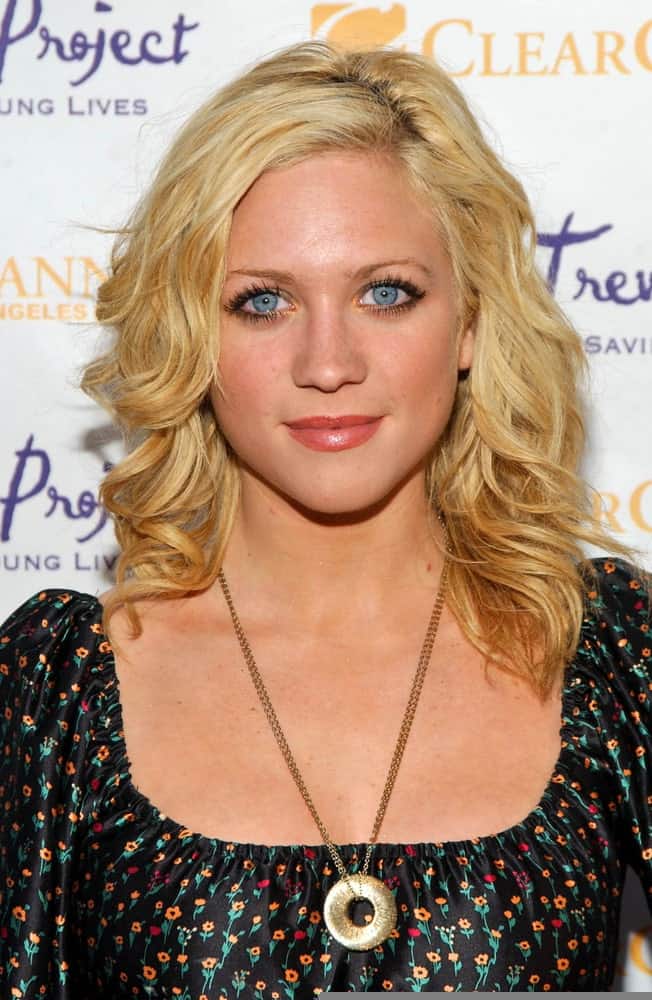 Brittany Snow was at The Trevor Project's "Cracked Xmas 9" Benefit at The Wiltern LG in Los Angeles, California on December 3, 2006. She wore a floral black dress with her shoulder-length tousled and curly blonde hairstyle that has highlights.