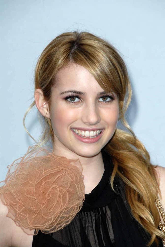 Emma Roberts attended the 2007/2008 Chanel Cruise Show Presented by Karl Lagerfeld at Hangar 8, Santa Monica, CA on May 18, 2007. She wore a lovely black dress with her low ponytail brunette hairstyle with long side-swept bangs.