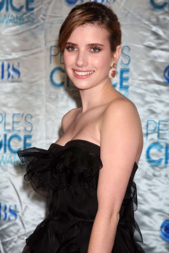 Emma Roberts was at the 2011 People's Choice Awards at Nokia Theater at LA Live on January 5, 2011 in Los Angeles, CA. She wore a strapless black dress with her brunette bun hairstyle with long side-swept bangs.