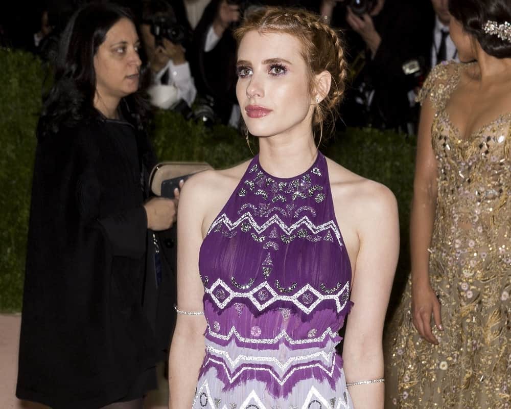 On May 2, 2016, Emma Roberts attended the Manus x Machina Fashion in an Age of Technology Costume Institute Gala at the Metropolitan Museum of Art in New York. She paired her patterned purple sundress with a brunette upstyle incorporated with braids.