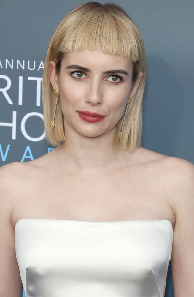 Emma Roberts was at the 23rd Annual Critics' Choice Awards held at the Barker Hangar in Santa Monica on January 11, 2018. She paired her pearly white strapless dress with a chin-length straight blonde hairstyle with short blunt bangs.