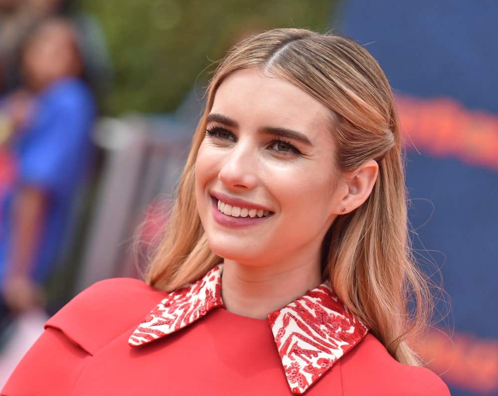 Emma Roberts attended the 'Ugly Dolls' World Premiere on April 27, 2019 in Los Angeles, CA. She wore a lovely red dress with her highlighted sandy blonde half-up hairstyle with a slight tousle.