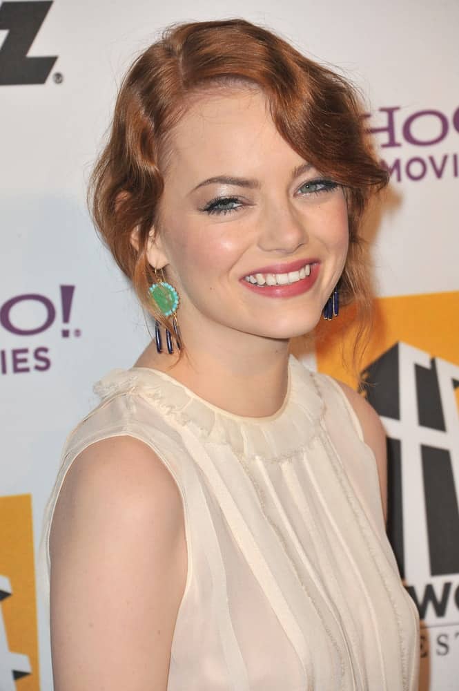 Emma Stone flashed her iconic beautiful smile with her wavy and loose red hairstyle that has a vintage look at the 15th Annual Hollywood Film Awards Gala at the Beverly Hilton Hotel on October 24, 2011 in Beverly Hills, CA.