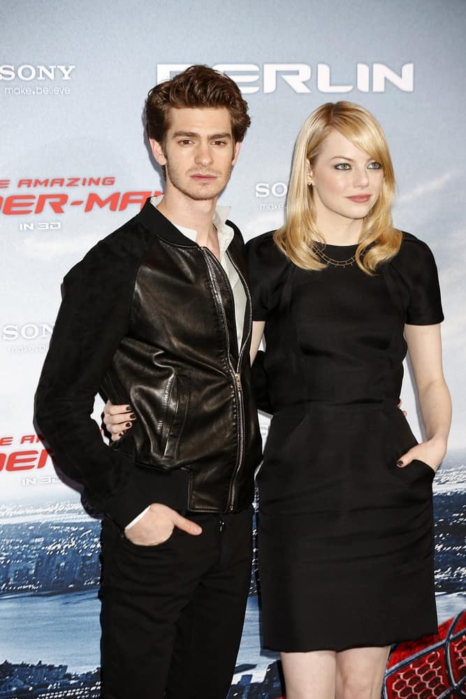 Andrew Garfield and Emma Stone wore matching black outfits at the photo call for "The Amazing Spider-Man" on June 20, 2012 in Berlin, Germany. Stone paired this with a medium-length straight blond hairstyle with side-swept bangs.