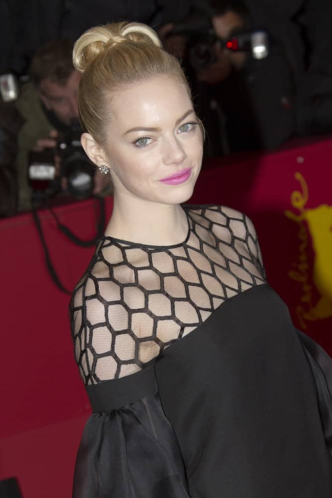 Emma Stone attended 'The Croods' Premiere during the 63rd Berlinale Film Festival at Berlinale Palast on February 15, 2013 in Berlin, Germany. She came in a vintage black dress that went quite well with her blond, and slick top knot bun hairstyle.