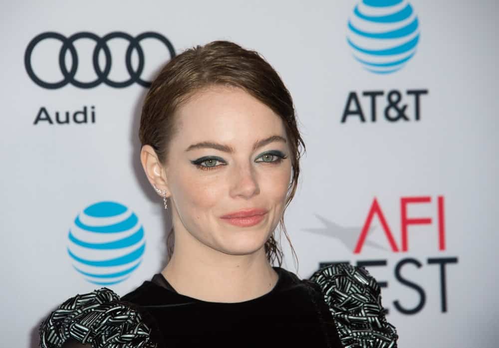 On November 15, 2016, Actress Emma Stone was at the gala screening for her movie "La La Land", part of the AFI FEST 2016, at the TCL Chinese Theatre, Hollywood. She came in a black dress that is paired 