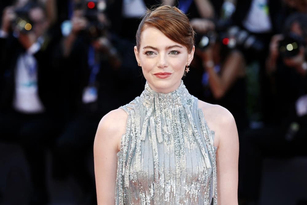 Actress Emma Stone sported an elegant upstyle that has side-swept bangs and a reddish brown hue when she attended the premiere of 'La La Land' during the 73rd Venice Film Festival on August 31, 2016 in Venice, Italy.