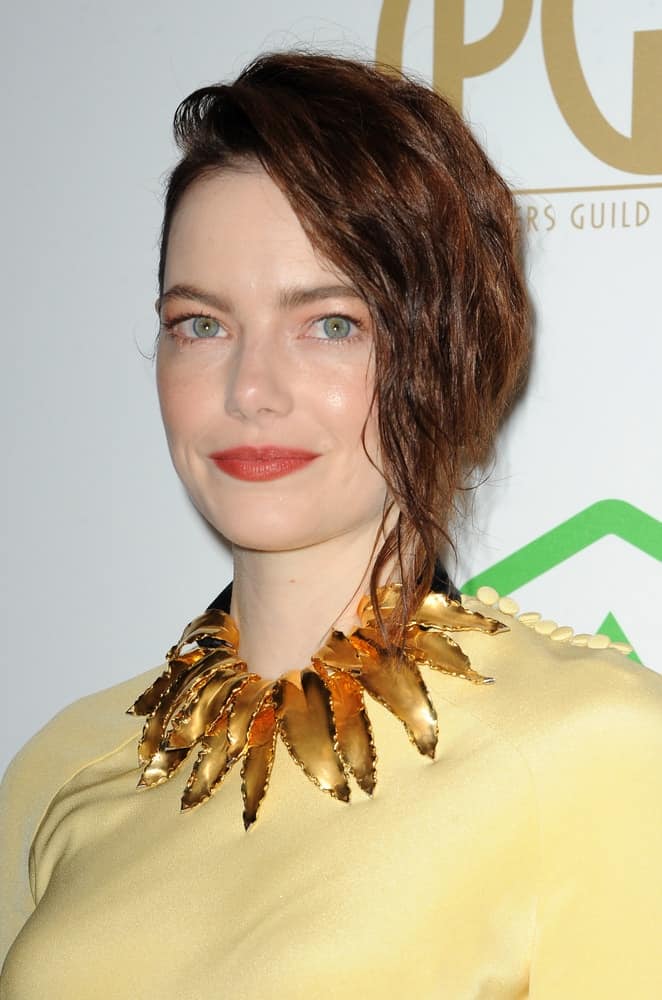 Emma Stone was quite fashionable and stylish with her gorgeous yellow dress, accessories and tousled side-swept hairstyle with a half up look at the 30th Annual Producers Guild Awards held at the Beverly Hilton Hotel in Beverly Hills on January 19, 2019.