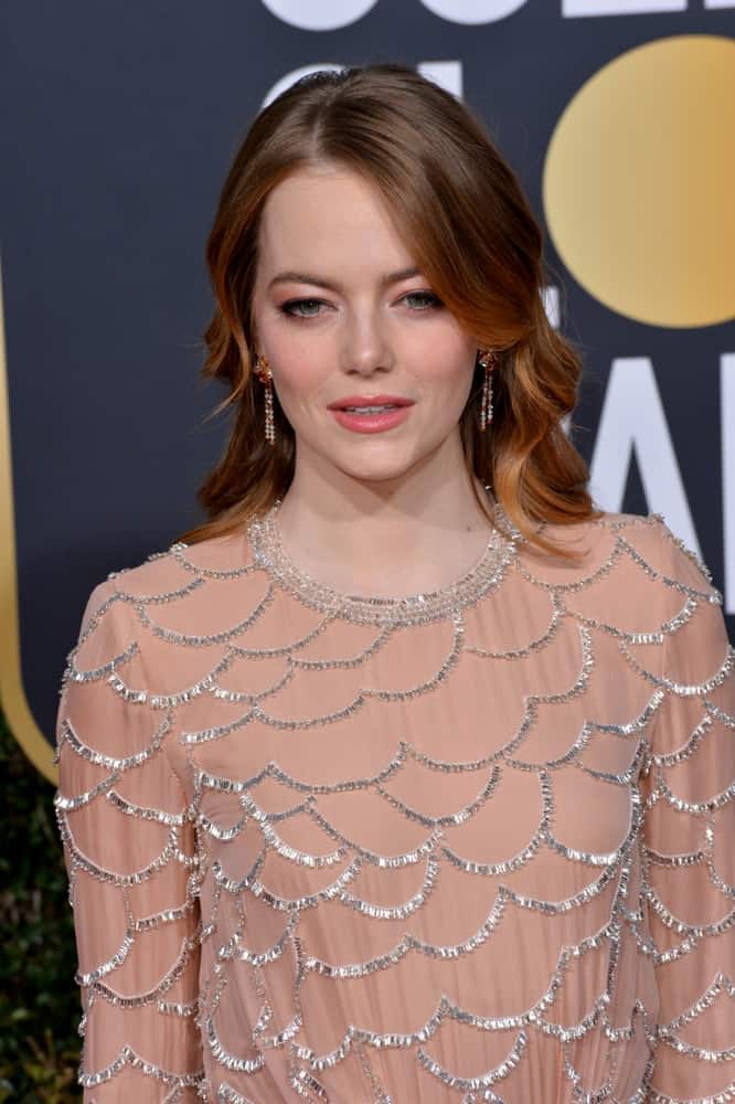 On January 06, 2019, Emma Stone attended the 2019 Golden Globe Awards at the Beverly Hilton Hotel. She wore an elegant blush dress with silver details to pair with her highlighted and layered wavy hairstyle.