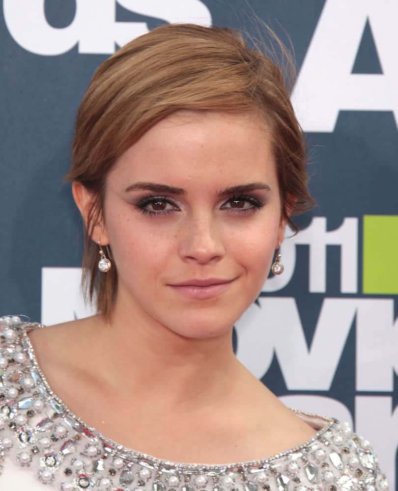Actress Emma Watson was at the MTV Movie Awards 2011 on June 05, 2011 in Hollywood, CA. She caught everyone's attention with her jeweled outfit and stylish tousled side-parted pixie hairstyle.