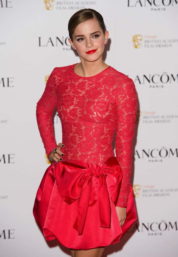 Emma Watson was at the Lancome pre BAFTA party at the Savoy Hotel in London on February 10, 2012. She wore a lovely red cocktail dress that totally paired well with her red lips and slick low bun hairstyle.