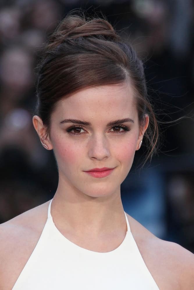 Emma Watson attended the UK premiere of 'Noah' at Odeon Leicester Square on March 31, 2014 in London, England. She was quite stunning in her white dress and messy high bun hairstyle that emphasizes her gorgeous neckline.