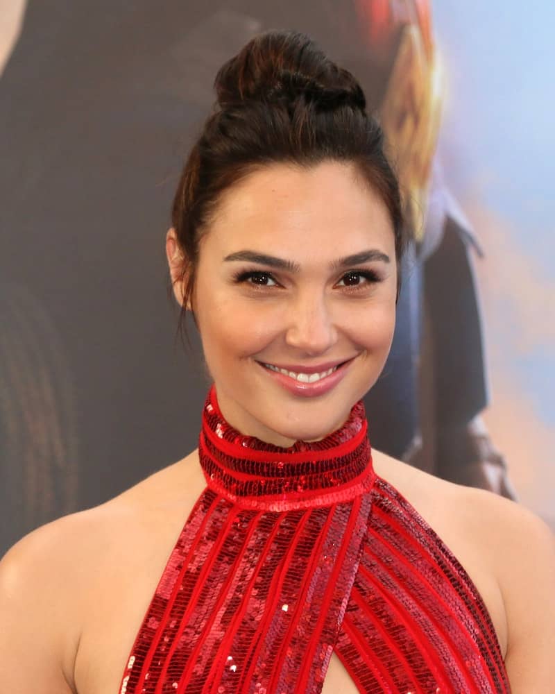 Gal Gadot attended the "Wonder Woman" in Los Angeles Premiere at the Pantages Theater on May 25, 2017 in Los Angeles, CA. She wore a red sequined dress to go with her top knot bun hairstyle and simple makeup.
