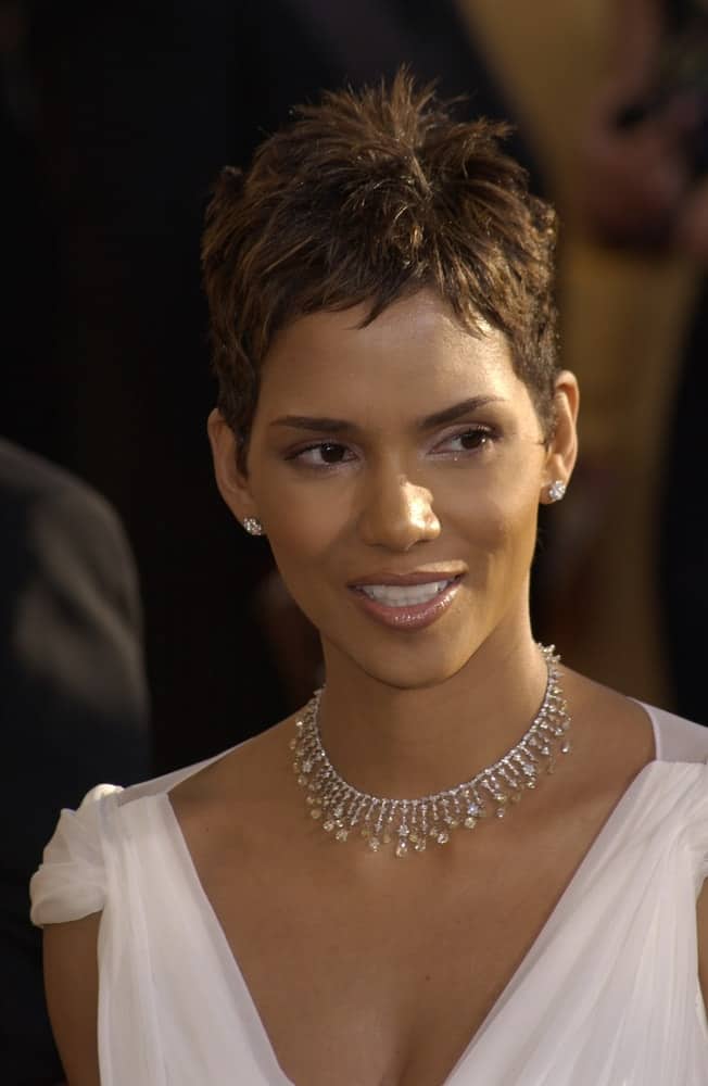 On March 10, 2002, Actress Halle Berry wore an elegant white dress with her lovely necklace and tousled pixie hairstyle at the 8th Annual Screen Actors Guild Awards in Los Angeles.