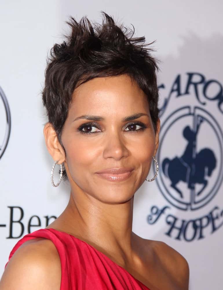 Halle Berry wore a goddess-cut red dress to match her equally sexy pixie hairstyle with a slight tousle and spikes at the Carousel of Hope 2010 on October 23,2010 in Beverly Hills, CA.
