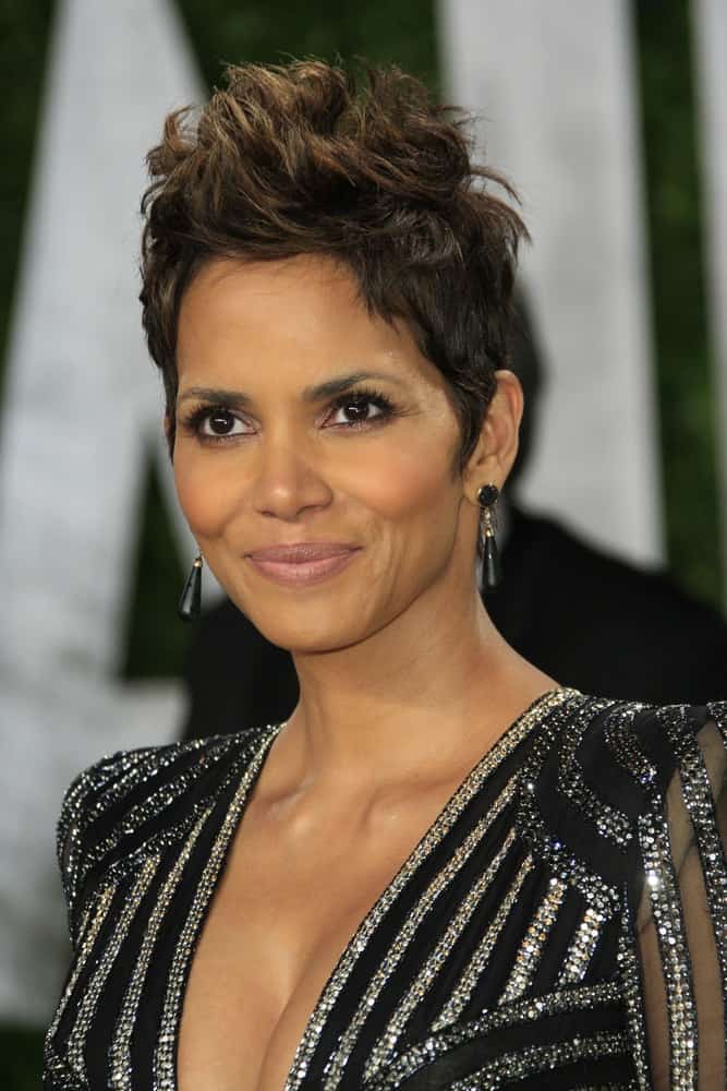 Halle Berry's spiked pixie hair had a slight faux-hawk look with highlights at the Vanity Fair Oscar Party at Sunset Tower on February 24, 2013 in West Hollywood, California.