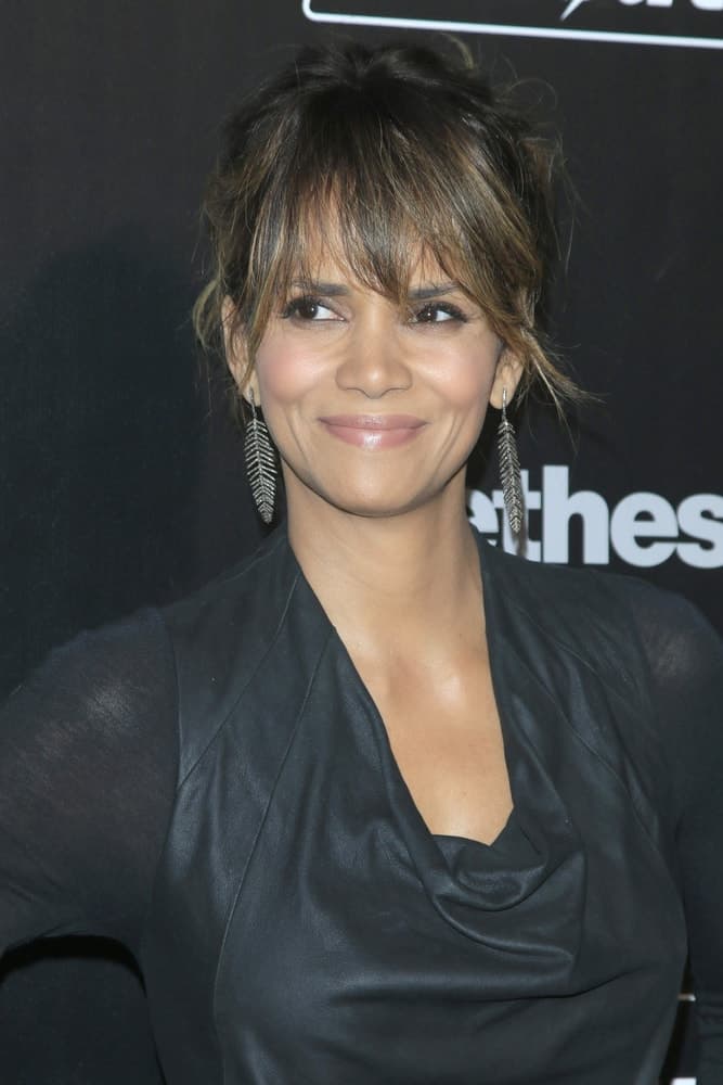Halle Berry showed off her lovely earrings with her messy bun hairstyle that has loose bangs at the Fallout 4 video game launch at the downtown on November 05, 2015 in Los Angeles, CA.
