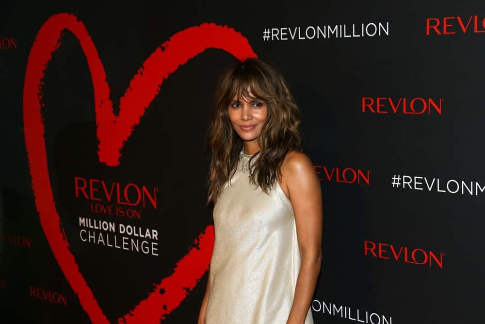 Actress Halle Berry attended Revlon's 2nd Annual Love Is On Million Dollar Challenge Finale Party at The Glasshouses on December 1, 2016 in New York City. She was stunning in her simple pearl white dress that complemented her loose and tousled wavy highlights.