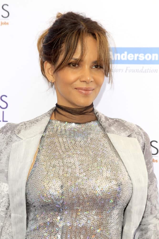 Halle Berry wore a stunning silver sequined dress that paired quite well with her messy bun hairstyle that has highlights and wispy bangs at the 16th Annual Chrysalis Butterfly Ball at the Private Estate on June 3, 2017 in Los Angeles, CA.