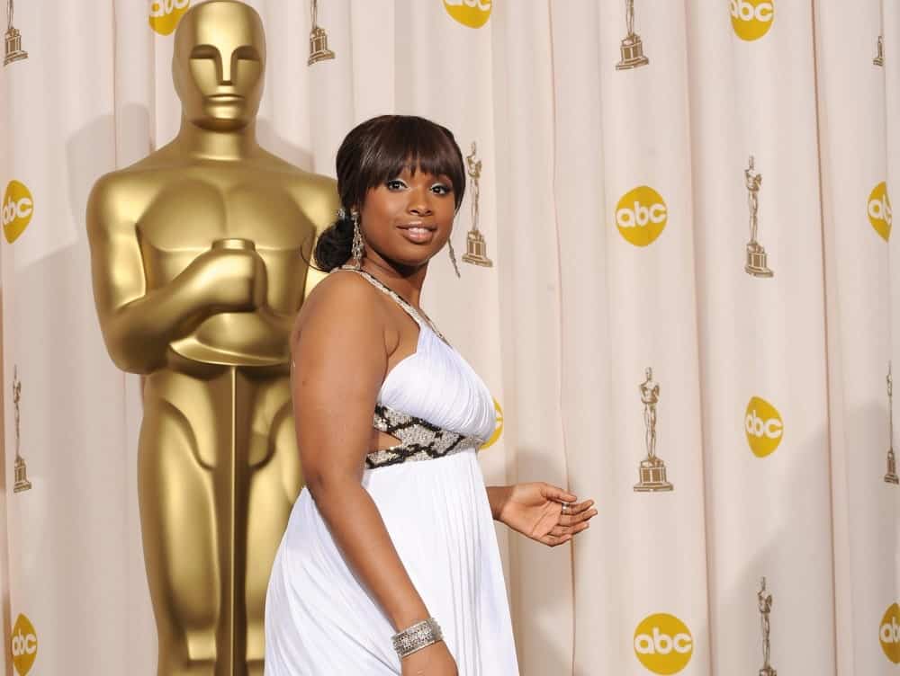 Jennifer Hudson was at the 80th Annual Academy Awards at the Kodak Theatre, Hollywood on February 24, 2008. She paired her lovely white dress with a low bun hairstyle that has blunt bangs.