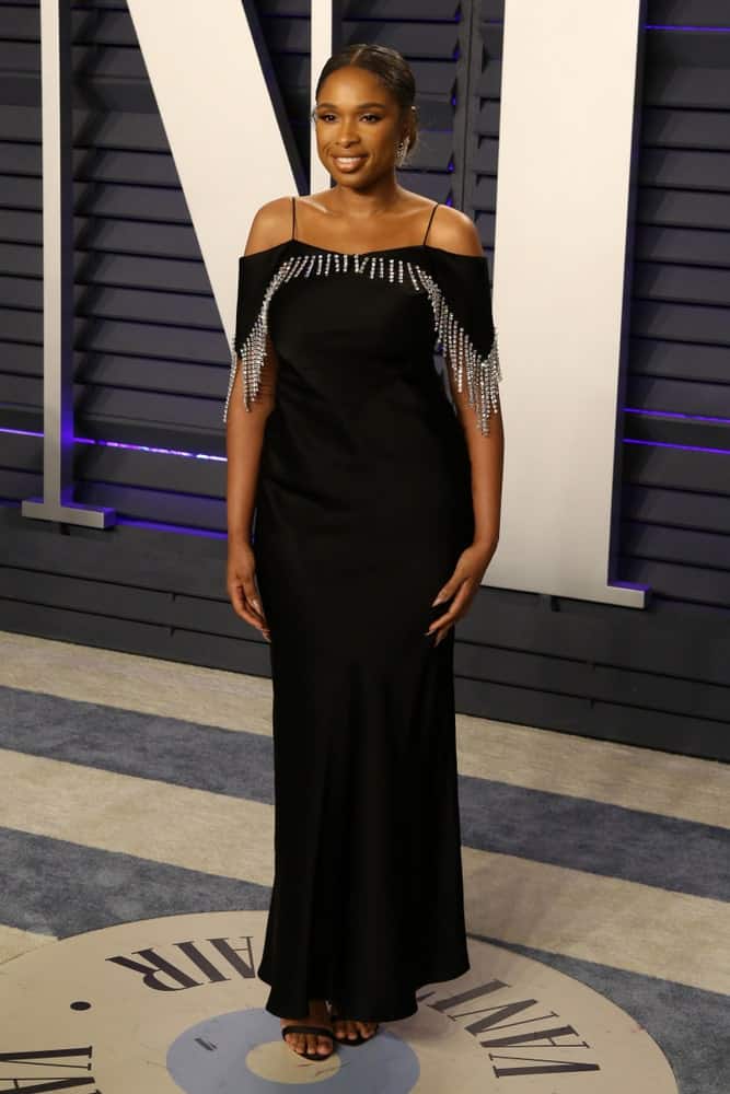 Jennifer Hudson was at the 2019 Vanity Fair Oscar Party on the Wallis Annenberg Center for the Performing Arts on February 24, 2019 in Beverly Hills, CA. She was seen wearing an elegant black dress with her slicked back bun hairstyle.