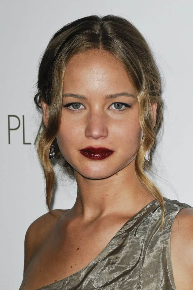 Jennifer Lawrence went with dark red lips to match with her messy bun hairstyle incorporated with loose wavy tendrils at "The Burning Plain" Premiere Party, Bond Street at Thompson Beverly Hills in Beverly Hills, CA on September 14, 2009.