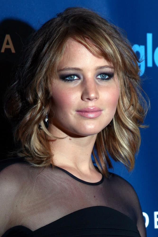 Jennifer Lawrence was at the 2013 GLAAD Media Awards at the JW Marriott on April 20, 2013 in Los Angeles, CA. Her elegant black sheer dress was a perfect fit for her loose and tousled wavy layered bob hairstyle with highlights.