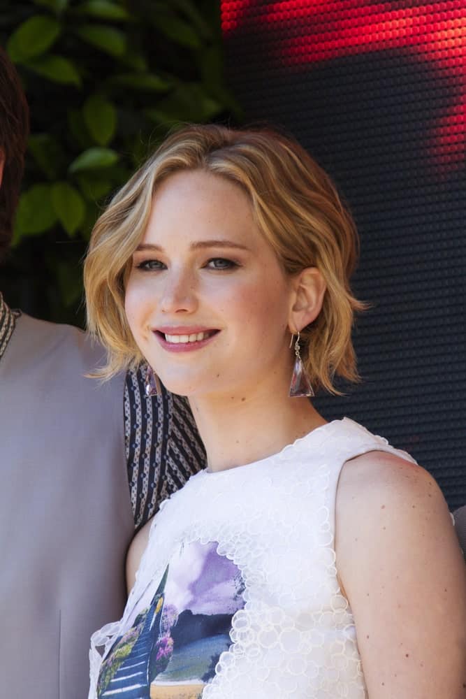 Jennifer Lawrence attended 'The Hunger Games: Mockingjay Part 1' Photocall - at the 67th Annual Cannes Film Festival on May 17, 2014 in Cannes, France. She came wearing a simple white outfit that went well with her short and tousled highlighted hairstyle.