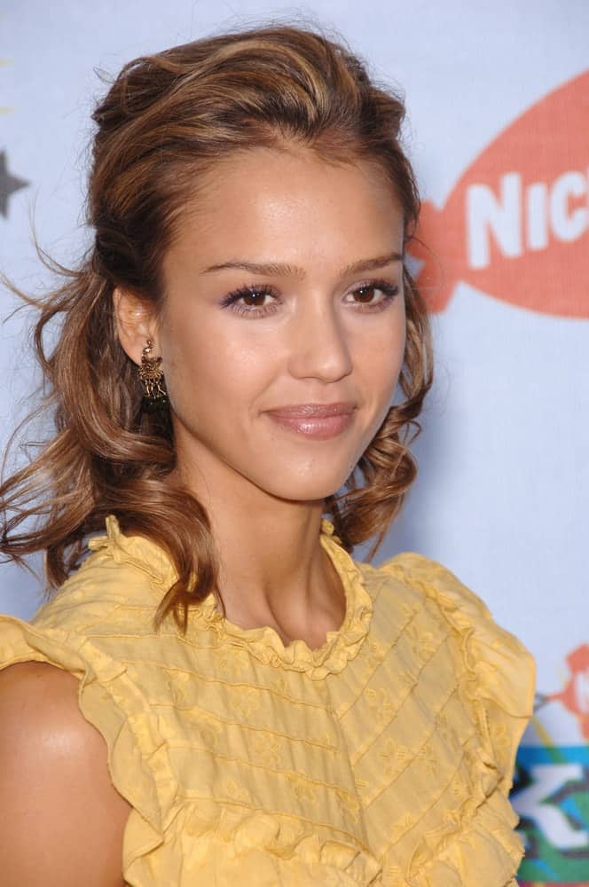 Actress Jessica Alba wore a simple and sweet yellow blouse with her brown half-up curly hairstyle with a slight tousle at the 2006 Nickelodeon Kids Choice Awards at UCLA, Los Angeles on April 1, 2006 in Los Angeles, CA.
