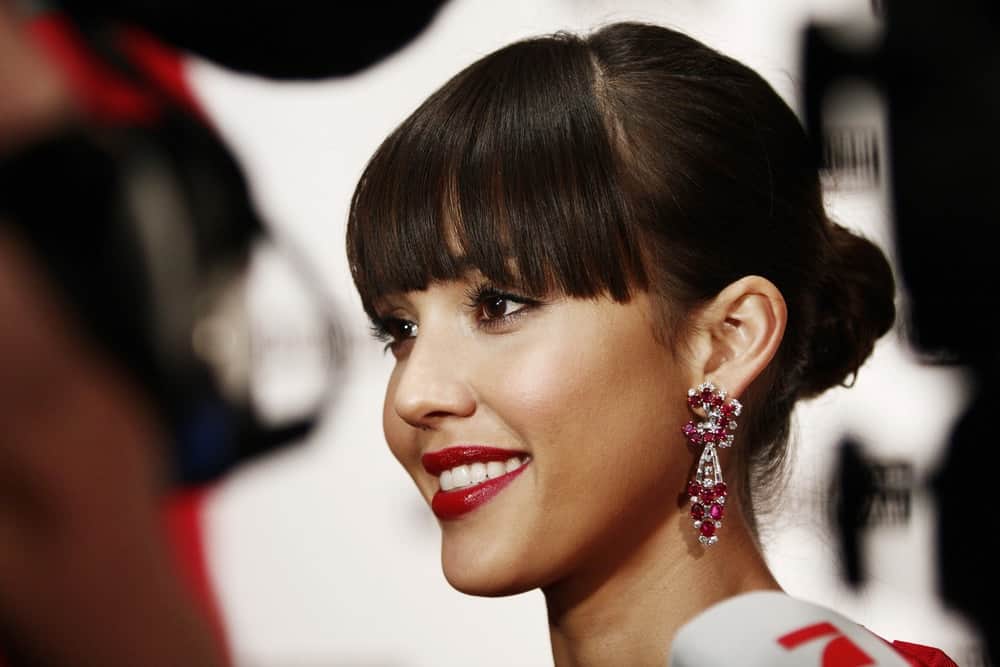 Actress Jessica Alba was quite stunning with her gorgeous earrings, red lips and elegant bun hairstyle with blunt bangs when she attended the Campari Calendar launch at La Permanente on December 2, 2008 in Milan, Italy.