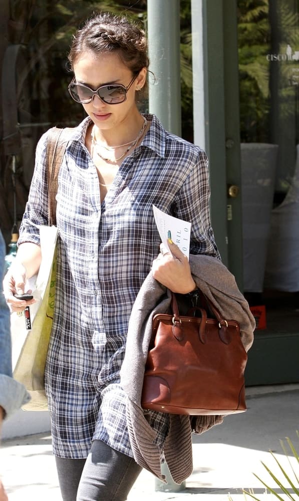 Jessica Alba was spotted walking the streets of Brentwood, CA on April 13, 2010. She was seen wearing a casual plaid outfit that she paired with a pair of cool sunglasses and neat upstyle bun hairstyle incorporated with braids at the side.