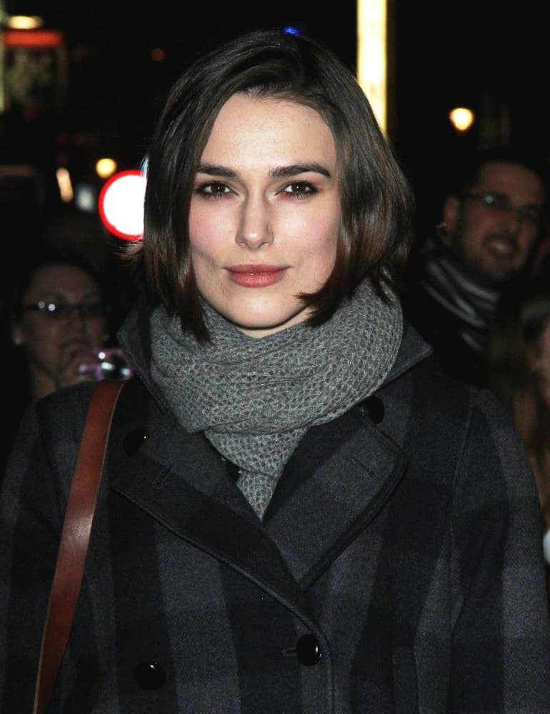 Keira Knightley seen walking the streets of London on November 21, 2011. She wore a plaid winter jacket and gray scarf to pair with her chin length straight and loose dark hairstyle.
