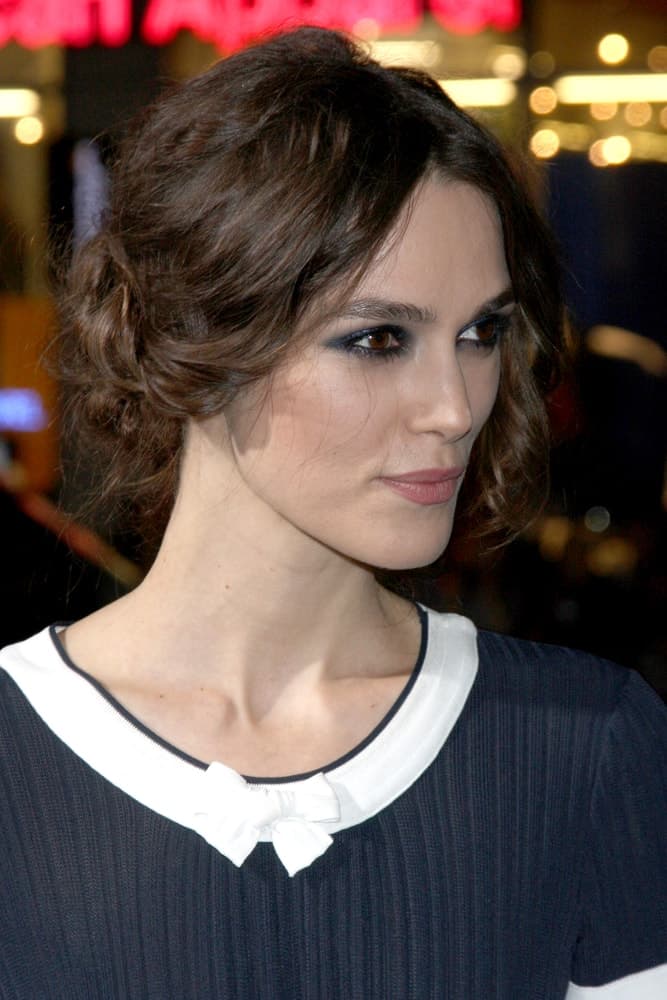 Keira Knightley was at the "Jack Ryan: Shadow Recruit" Los Angeles Premiere at TCL Chinese Theater on January 15, 2014, in Los Angeles, CA. She paired her simple dress with a messy low bun hairstyle with wavy bangs.