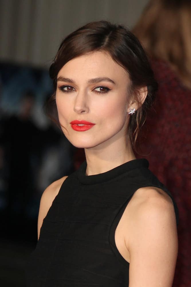 Keira Knightley attended the UK Premiere of 'Jack Ryan: Shadow Recruit' at the Vue Leicester Square on January 20, 2014, in London, England. She was seen in a black dress and a messy low bun hairstyle with loose tendrils on the sides.