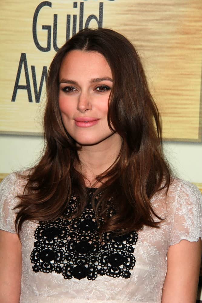 Keira Knightley was at the 2015 Writers Guild Awards at a Century Plaza Hotel on February 14, 2015, in Century City, California. Her detailed black and white dress paired well with her long and wavy layered hairstyle with highlights.