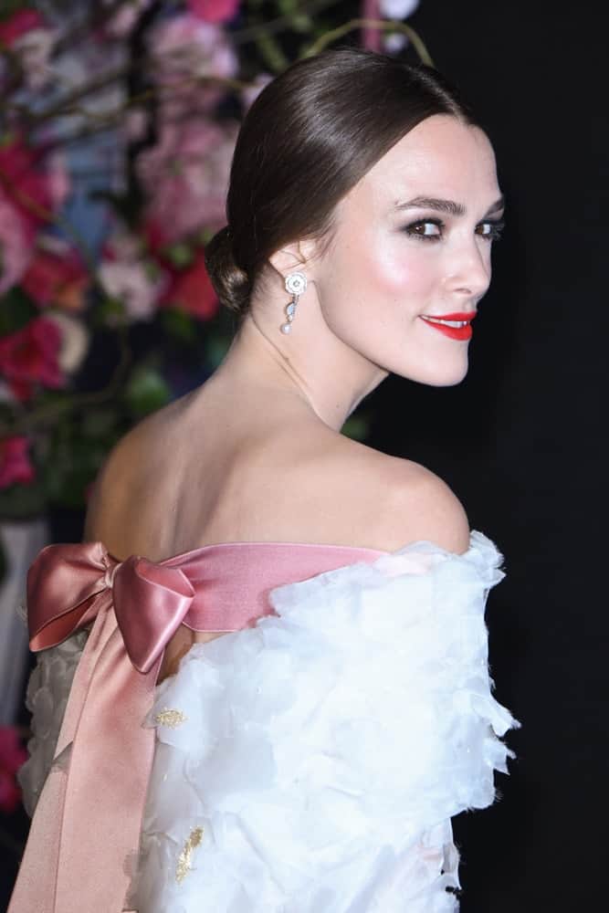 On November 01, 2018, Keira Knightley was at the European premiere of "The Nutcracker and the Four Realms" at the Vue Westfield, White City, London. She wore a charming white dress with her slick low bun hairstyle.