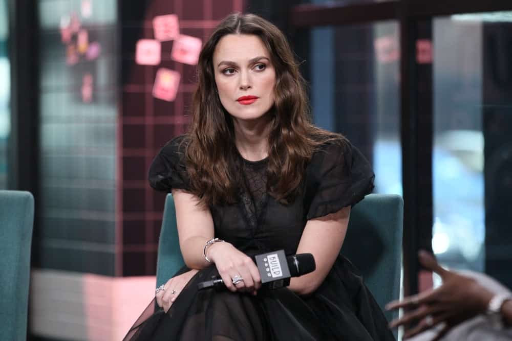 Keira Knightley was at The Tuesday show on March 12, 2019 at the BUILD Studio in New York, NY. She wore an elegant black dress to pair with her medium-length, loose and tousled wavy brunette hairstyle with subtle highlights.
