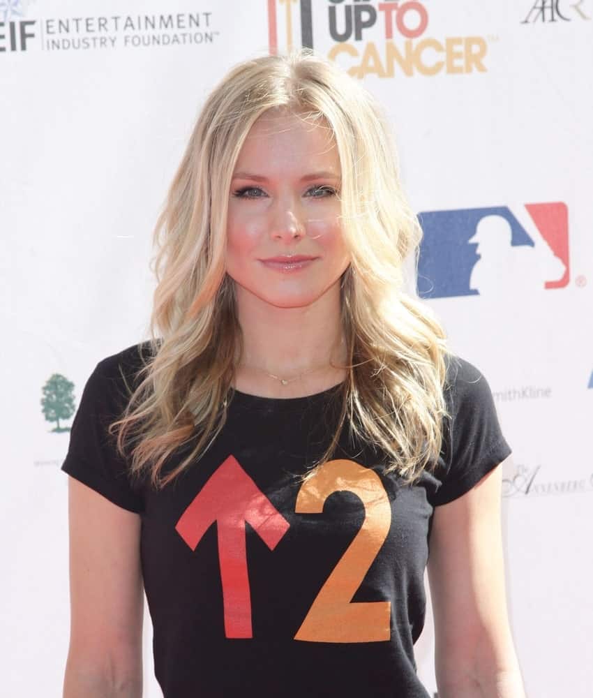 Kristen Bell in attendance for Stand Up To Cancer Fundraiser at Sony Pictures Studios, Los Angeles, CA on September 10, 2010. She had a blonde center-parted wavy hairstyle that contrasts her black shirt.
