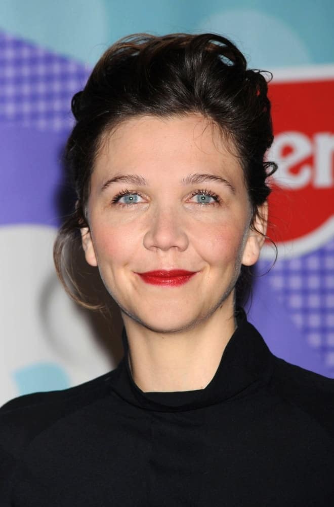 Maggie Gyllenhaal attended the press conference for Fisher-Price Launch of the Precious Planet BabyGear Collection in New York, NY on January 27, 2009. She wore a simple black outfit with her messy dark ponytail hairstyle with loose tendrils.
