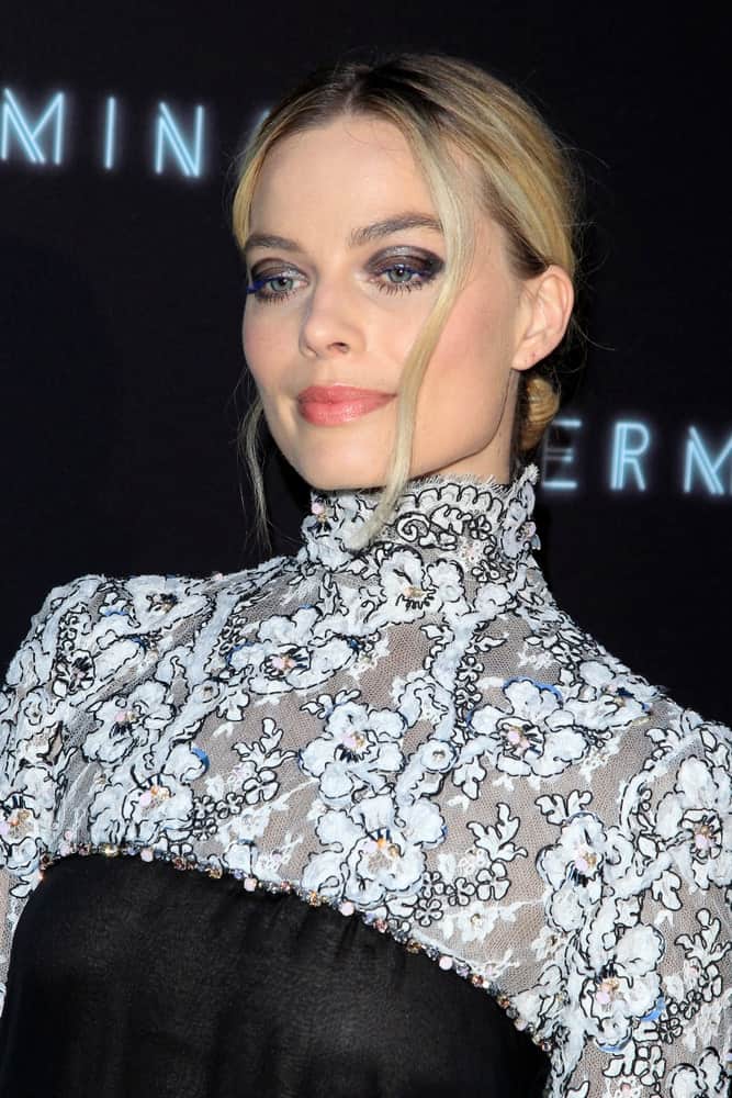 Margot Robbie had a low bun hairstyle with loose tendrils at the "Terminal" Premiere held at the ArcLight Theater on May 8, 2018, in Los Angeles CA.