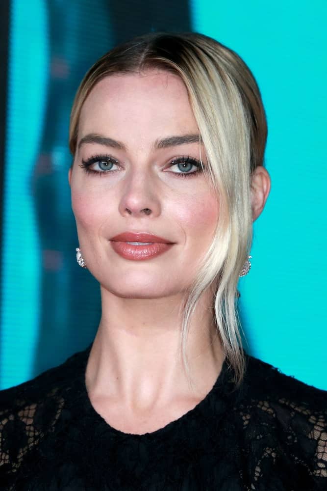 Margot Robbie pulled off a neat center-parted upstyle with long side tendrils as she attends the British Academy Film Awards at the Royal Albert Hall on February 2, 2020.