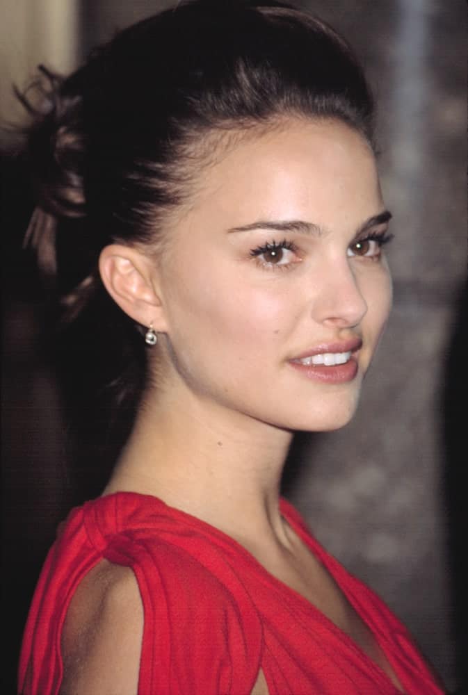 Natalie Portman went with a brushed-back pompadour look to her upstyle bun hairstyle with loose tendrils at the VH1 VOGUE FASHION AWARDS held in New York on October 15, 2002.
