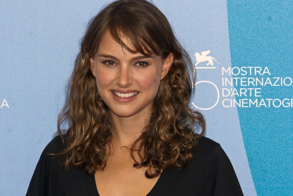 Director Natalie Portman attended the Eve photocall at the Piazzale del Casino during the 65th Venice Film Festival on September 2, 2008 in Venice, Italy. She wore a simple black outfit that complements her medium length loose and tousled curly hairstyle with bangs.