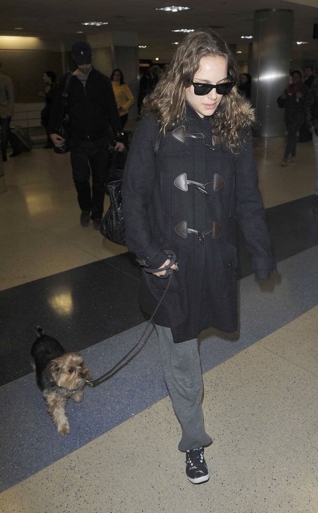 Best actress Academy Award winner Natalie Portman was seen with her dog at LAX airport on February 22, 2010 in Los Angeles, California. She wore a large black coat to pair her casual outfit and long tousled loose hairstyle.